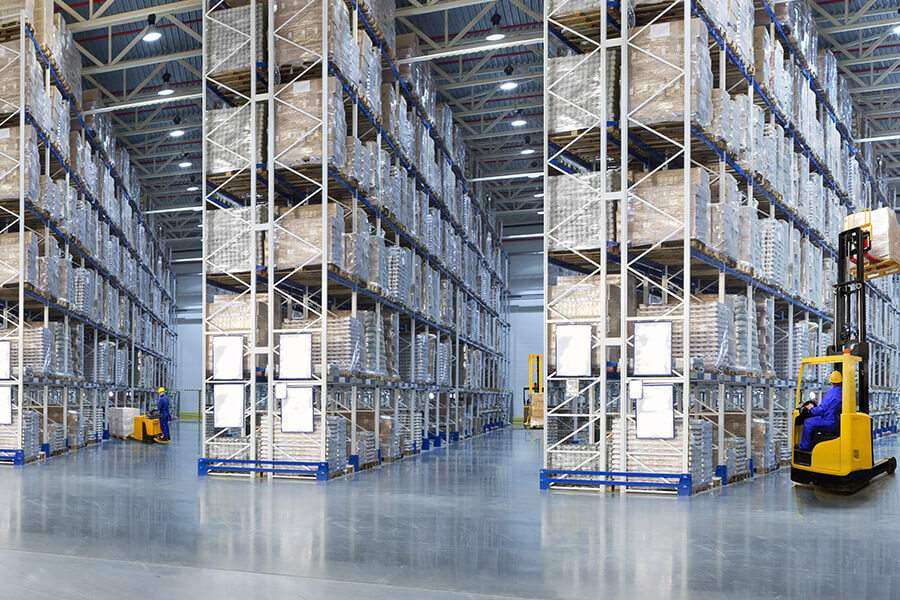 A large warehouse filled with lots of pallets.