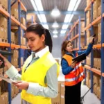 Warehouse team performing physical stock verification and comparing it with book stock records during an inventory reconciliation process.