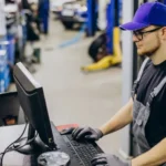 Automotive warehouse manager reviewing automobile spare parts inventory to balance availability and avoid over-stocking