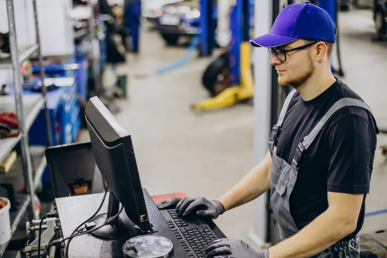 Automotive warehouse manager reviewing automobile spare parts inventory to balance availability and avoid over-stocking