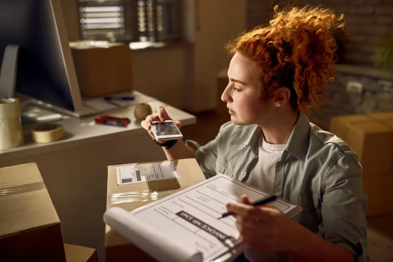 Inventory manager analyzing the hidden carrying costs of stock stored in a modern warehouse