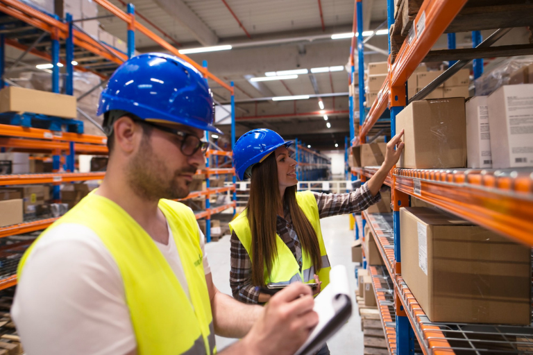 Organised warehouse with labelled storage racks, clear aisles and inventory arranged for efficient stock management